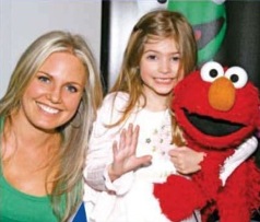 children0024.jpg - Terri and daughter Julia with Elmo at the opening night of ImaginOcean on March 31, 2010 at New World Stages, New York City, New York